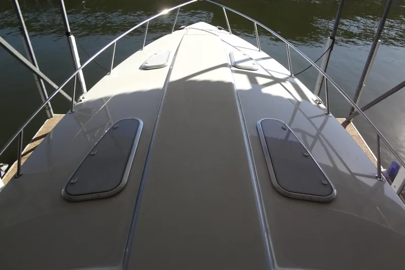 Double Double Yacht Photos Pics 2019 Formula 400 Super Sport boat deck with hatches and railing, docked by water.