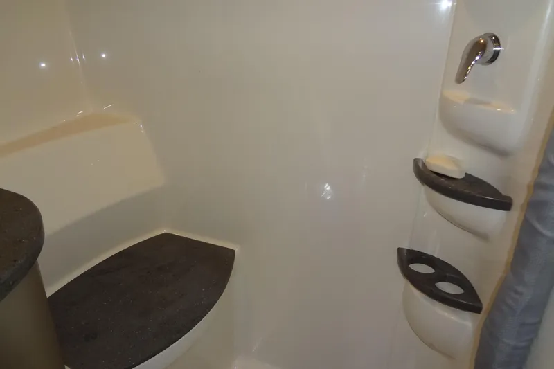 Double Double Yacht Photos Pics Interior of 2019 Formula 400 Super Sport boat bathroom with seating and storage shelves.