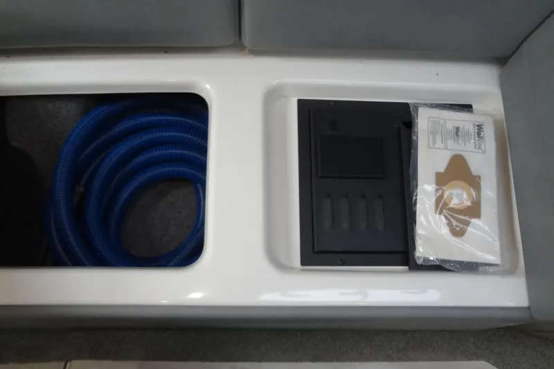Double Double Yacht Photos Pics 2019 Formula 400 Super Sport storage compartment with blue hose and accessories.