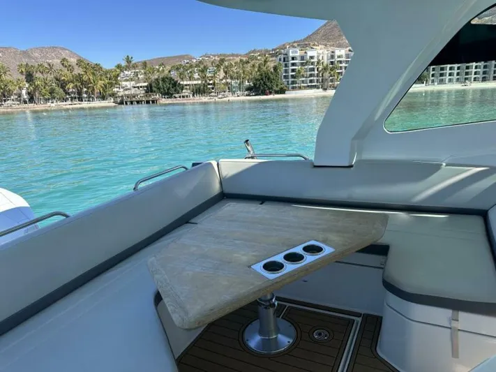 Debbie Yacht Photos Pics 2021 Beneteau Gran Turismo 32 yacht interior with table, overlooking serene coastal view.