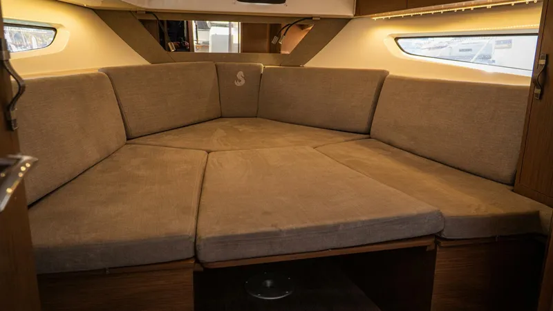 Debbie Yacht Photos Pics 2021 Beneteau Gran Turismo 32 interior cabin with beige seating and natural light.