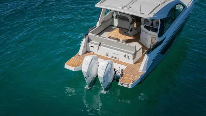 Debbie Yacht Photos Pics 2021 Beneteau Gran Turismo 32 yacht with twin outboard engines on clear water.