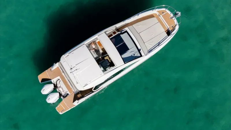 Debbie Yacht Photos Pics Aerial view of 2021 Beneteau Gran Turismo 32 yacht on turquoise water.
