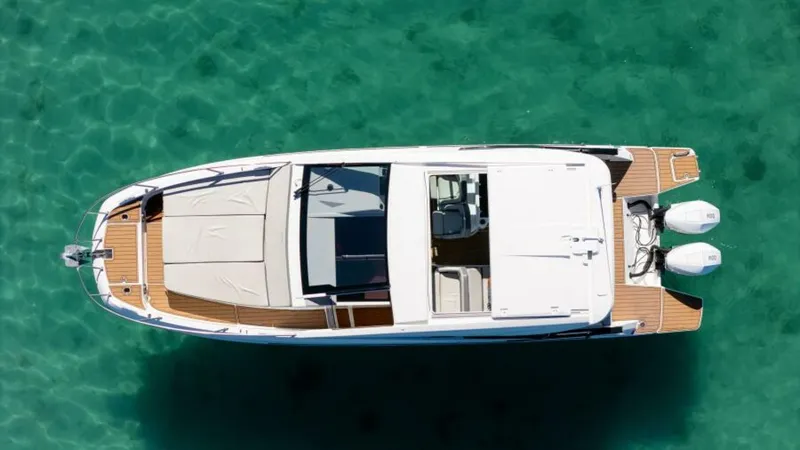 Debbie Yacht Photos Pics 2021 Beneteau Gran Turismo 32 yacht on clear turquoise water, aerial view.