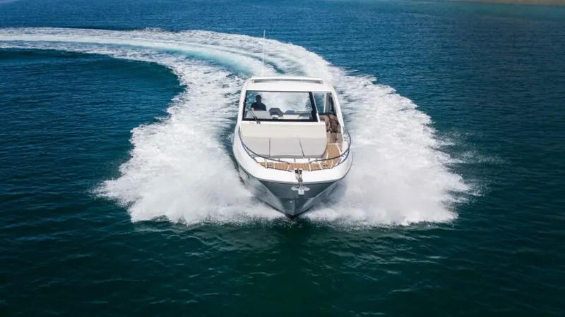 Debbie Yacht Photos Pics 2021 Beneteau Gran Turismo 32 cruising on open water, creating a dynamic wake.