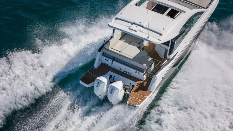 Debbie Yacht Photos Pics 2021 Beneteau Gran Turismo 32 cruising on water, rear view, powerful twin engines.