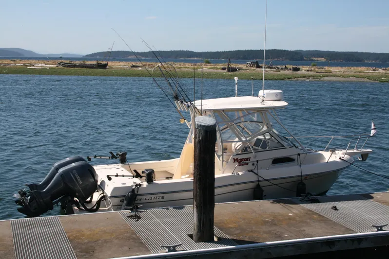 Monkey King Yacht Photos Pics 2021 Grady-White 232 Gulfstream boat docked by the water with fishing rods.