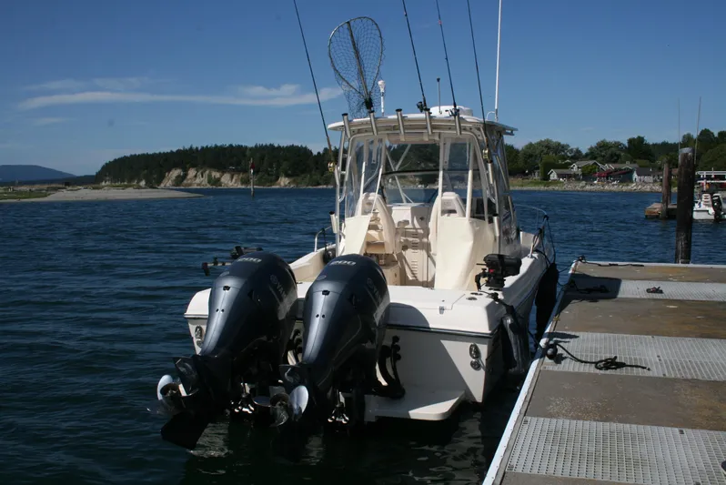 Monkey King Yacht Photos Pics 2021 Grady-White 232 Gulfstream boat docked with dual outboard motors.