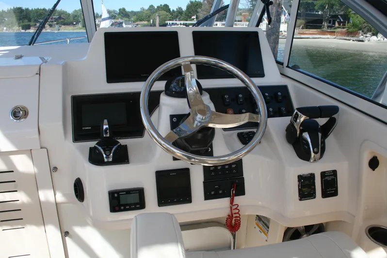 Monkey King Yacht Photos Pics 2021 Grady-White 232 Gulfstream boat dashboard with steering wheel and navigation controls.