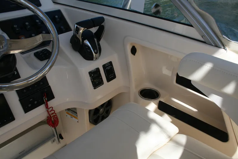 Monkey King Yacht Photos Pics 2021 Grady-White 232 Gulfstream boat cockpit with steering wheel and controls.