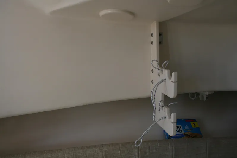 Monkey King Yacht Photos Pics Interior view of 2021 Grady-White 232 Gulfstream boat with storage hooks and a snack box.