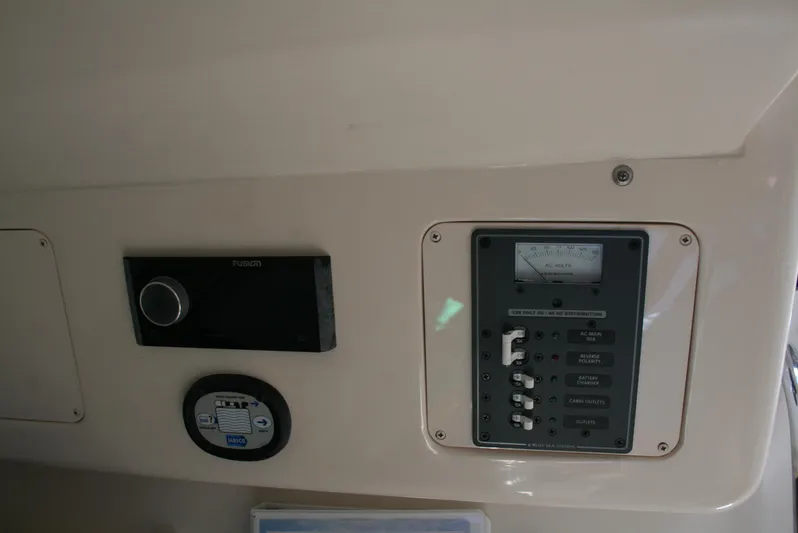 Monkey King Yacht Photos Pics Control panel of 2021 Grady-White 232 Gulfstream boat, featuring switches and a voltage meter.
