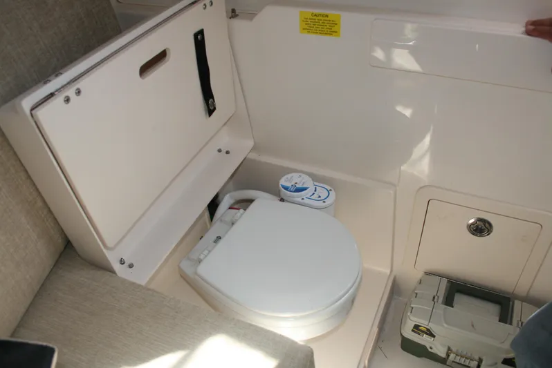 Monkey King Yacht Photos Pics 2021 Grady-White 232 Gulfstream boat interior with compact marine toilet.