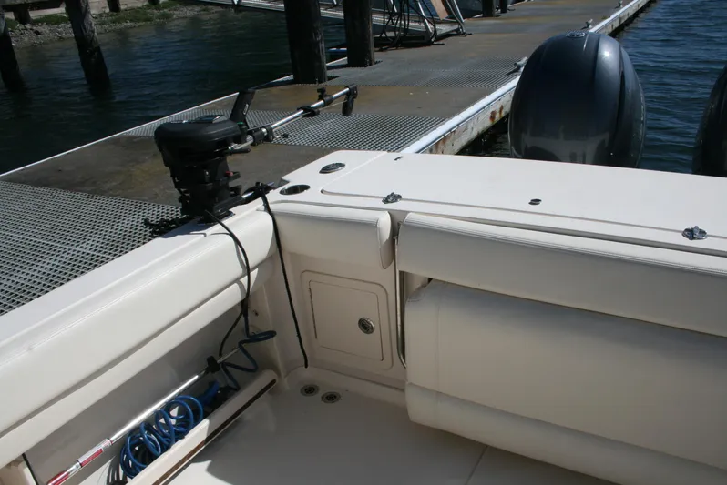 Monkey King Yacht Photos Pics 2021 Grady-White 232 Gulfstream boat interior with docked engines and fishing equipment.