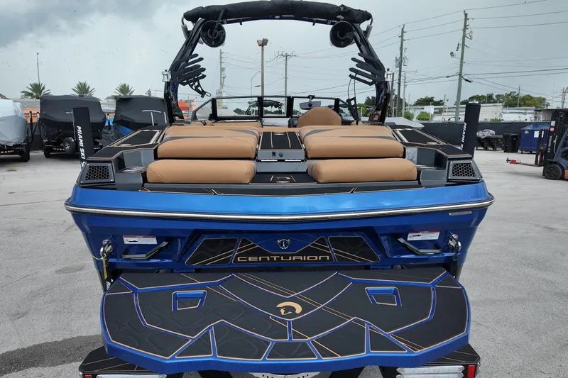  Yacht Photos Pics 2025 Centurion Fe23 boat, blue exterior, tan seating, parked outdoors.