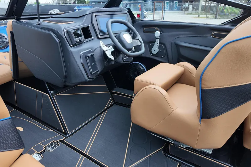  Yacht Photos Pics 2025 Centurion Fe23 boat interior with tan leather seats and modern dashboard.