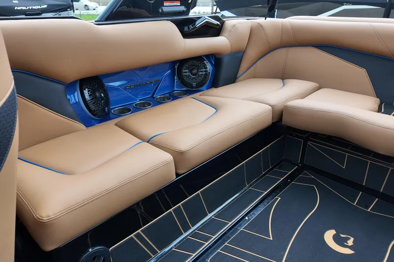  Yacht Photos Pics Luxurious interior of 2025 Centurion Fe23 boat with tan leather seating and blue accents.