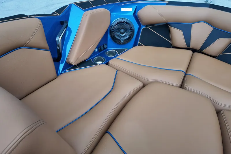  Yacht Photos Pics Luxurious interior of 2025 Centurion Fe23 boat with tan seating and blue accents.