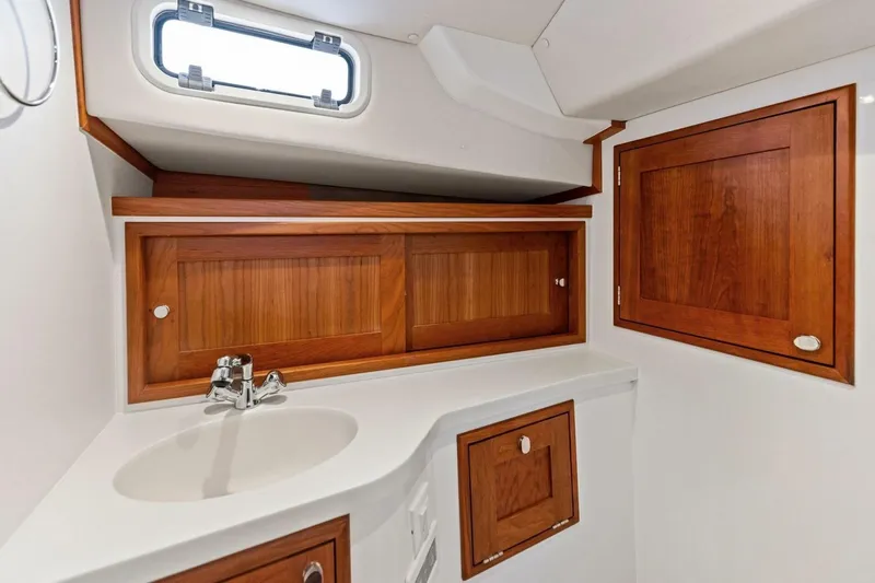  Yacht Photos Pics 2025 MJM 35 yacht bathroom with wooden cabinets and modern sink design.