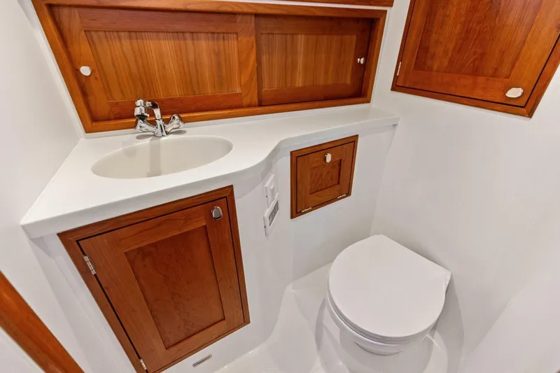  Yacht Photos Pics 2025 MJM 35 yacht bathroom with wooden cabinets and modern fixtures.