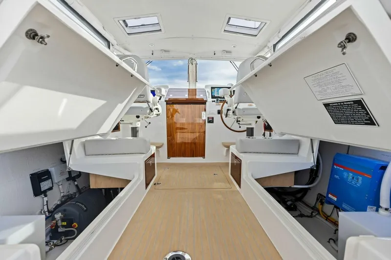  Yacht Photos Pics Interior view of 2025 MJM 35 boat showcasing seating and equipment storage.