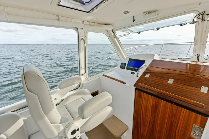  Yacht Photos Pics Interior of 2025 MJM 35 boat with helm, luxurious seating, and ocean view.