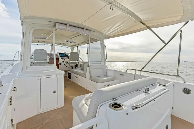  Yacht Photos Pics 2025 MJM 35 boat interior with seating, helm, and canopy on open water.