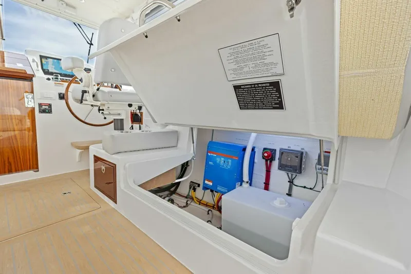  Yacht Photos Pics 2025 MJM 35 boat interior showing helm and storage compartment with electrical components.