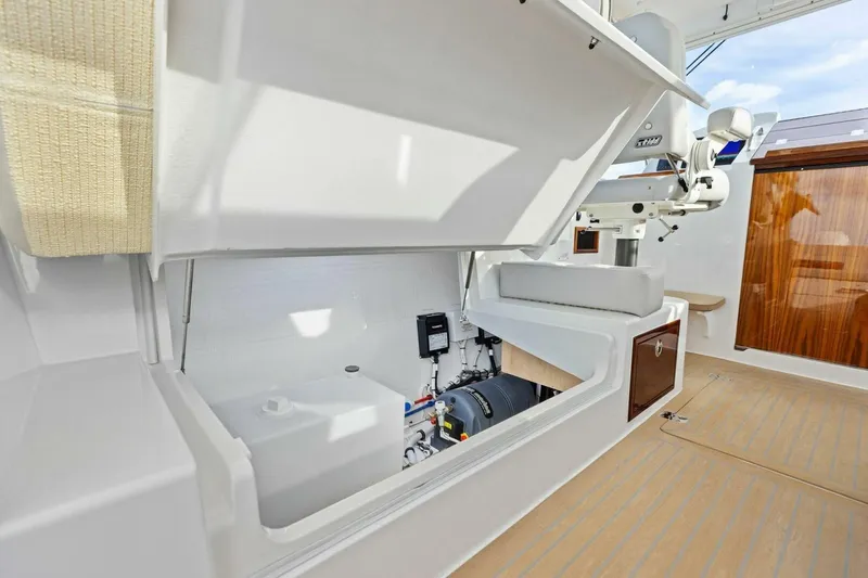  Yacht Photos Pics 2025 MJM 35 yacht interior storage compartment with open hatch and visible equipment.