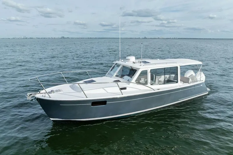  Yacht Photos Pics 2025 MJM 35 boat cruising on open water under a cloudy sky.