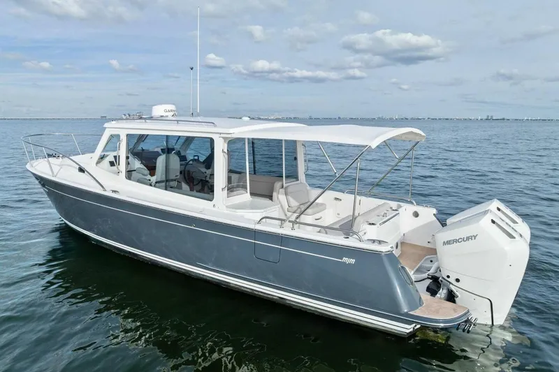  Yacht Photos Pics 2025 MJM 35 boat on calm water with Mercury outboard engine.