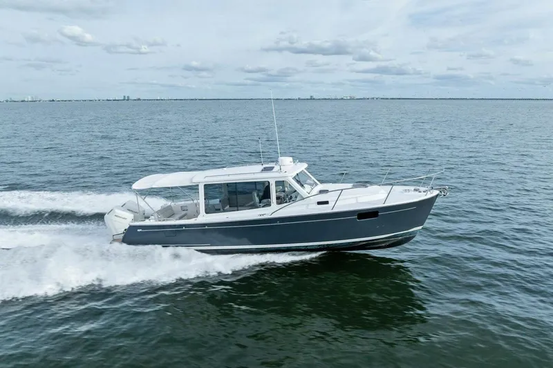  Yacht Photos Pics 2025 MJM 35 boat cruising on open water under a cloudy sky.