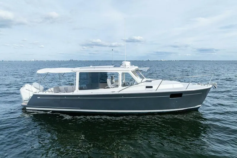  Yacht Photos Pics 2025 MJM 35 boat on calm ocean waters under a cloudy sky.