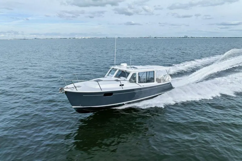  Yacht Photos Pics 2025 MJM 35 boat cruising on open water under a cloudy sky.