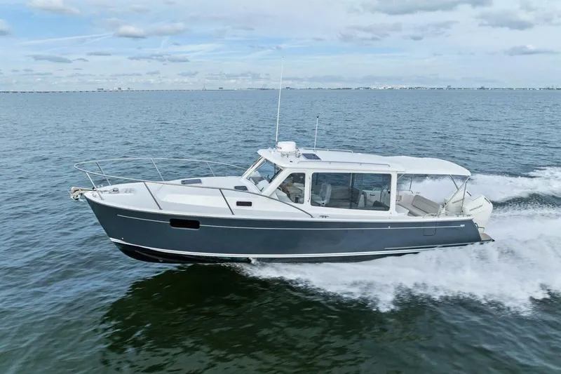  Yacht Photos Pics 2025 MJM 35 boat cruising on open water under a cloudy sky.