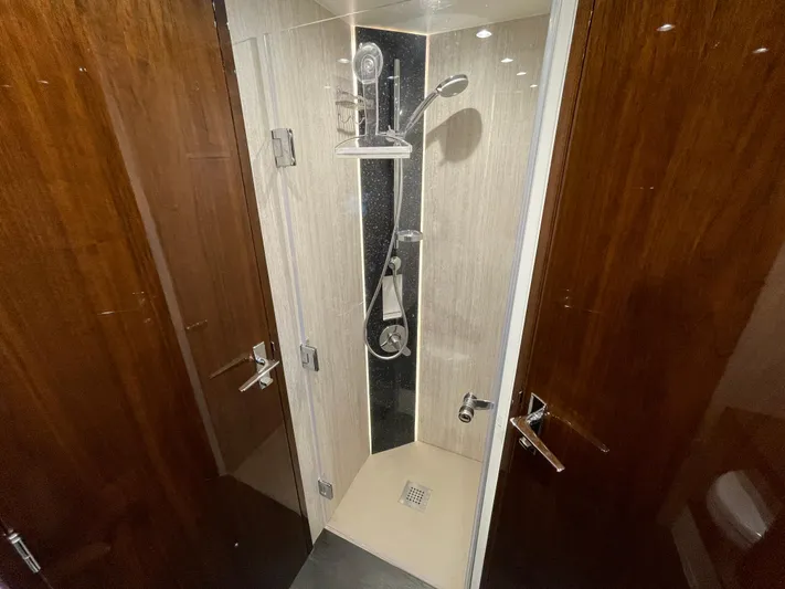  Yacht Photos Pics Shower area in 2017 Fairline Squadron 48 yacht with modern fixtures and wooden accents.