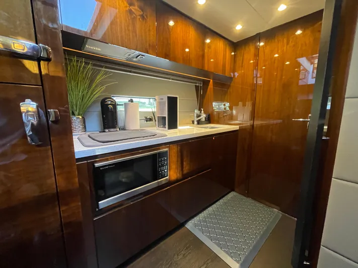  Yacht Photos Pics Luxurious galley in 2017 Fairline Squadron 48 yacht with modern appliances and wood finish.