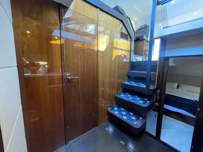  Yacht Photos Pics Interior of 2017 Fairline Squadron 48 yacht with wooden paneling and modern staircase.