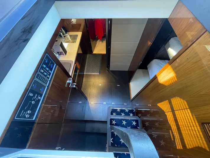  Yacht Photos Pics Interior of 2017 Fairline Squadron 48 yacht, featuring modern kitchen and cozy sleeping area.