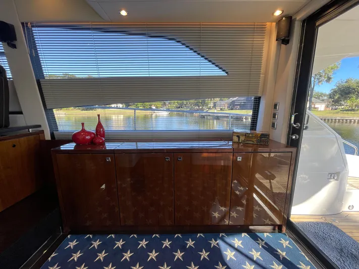  Yacht Photos Pics Interior of 2017 Fairline Squadron 48 yacht with wooden cabinetry and scenic window view.