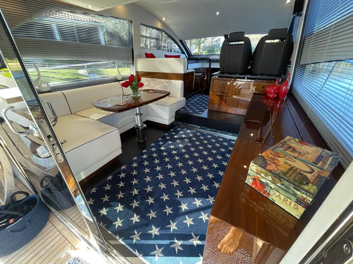  Yacht Photos Pics Luxurious interior of 2017 Fairline Squadron 48 yacht with elegant seating and star-patterned carpet.