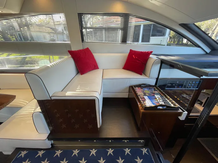  Yacht Photos Pics Interior of 2017 Fairline Squadron 48 yacht with white seating and red cushions.