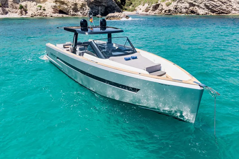  Yacht Photos Pics 2018 Fjord 52 Open yacht cruising in clear turquoise waters near rocky coastline.