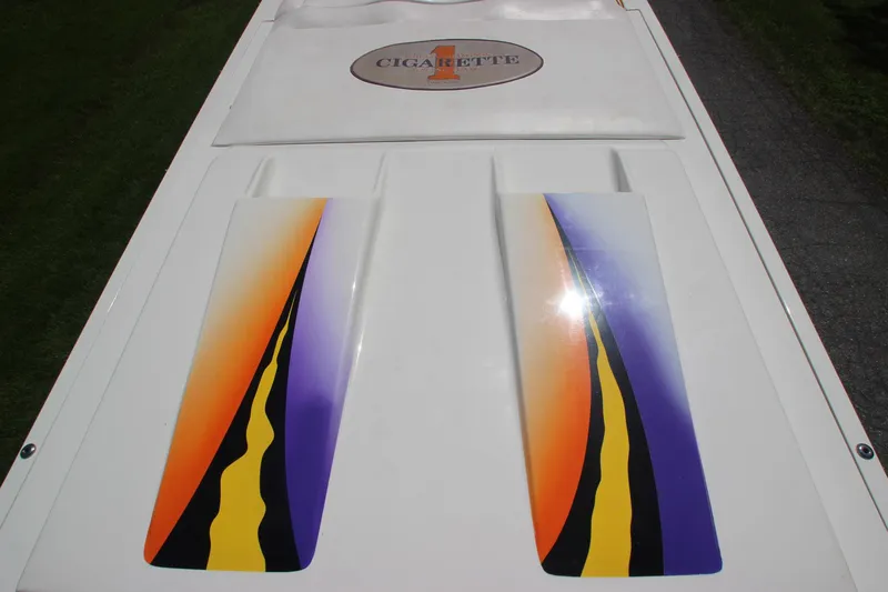  Yacht Photos Pics 2001 Cigarette 46 Rough Rider boat with vibrant orange, yellow, and purple graphics on deck.