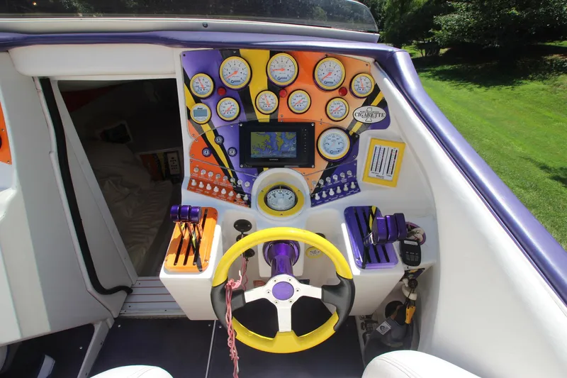  Yacht Photos Pics 2001 Cigarette 46 Rough Rider boat dashboard with colorful gauges and steering wheel.