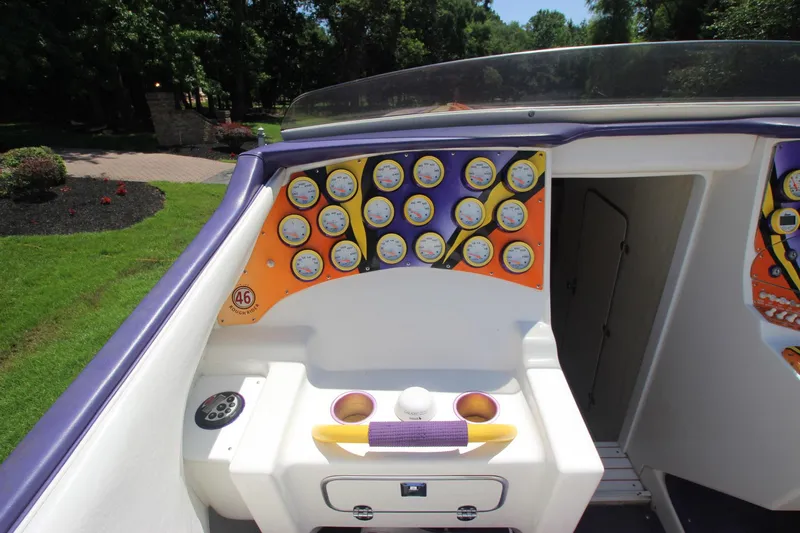  Yacht Photos Pics 2001 Cigarette 46 Rough Rider boat dashboard with multiple gauges and vibrant orange accents.
