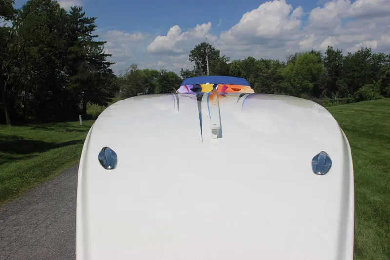  Yacht Photos Pics 2001 Cigarette 46 Rough Rider boat on a scenic road with trees and blue sky.
