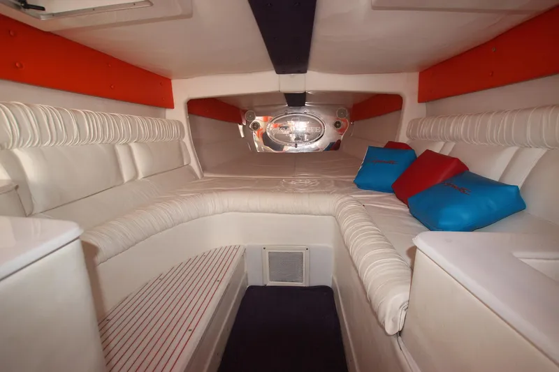  Yacht Photos Pics Interior of 2001 Cigarette 46 Rough Rider boat with cushioned seating and colorful pillows.