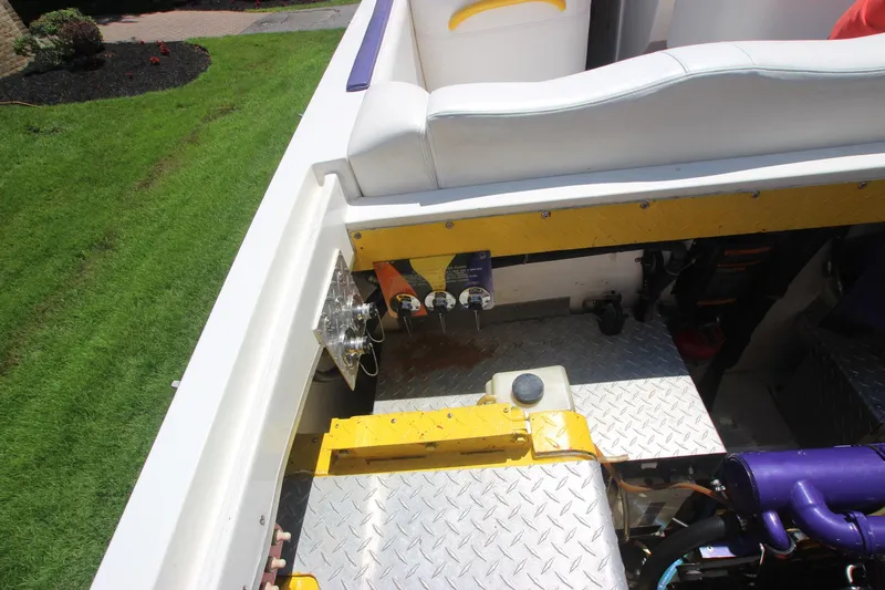  Yacht Photos Pics 2001 Cigarette 46 Rough Rider boat interior with engine compartment and seating.