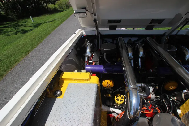  Yacht Photos Pics Engine compartment of a 2001 Cigarette 46 Rough Rider boat, featuring chrome exhaust pipes.